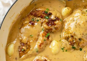 creamy garlic chicken: tender seared chicken breasts smothered in a velvety garlic sauce with savory Italian spices