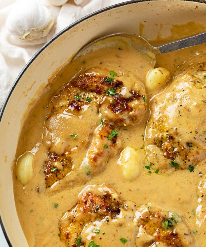 creamy garlic chicken: tender seared chicken breasts smothered in a velvety garlic sauce with savory Italian spices