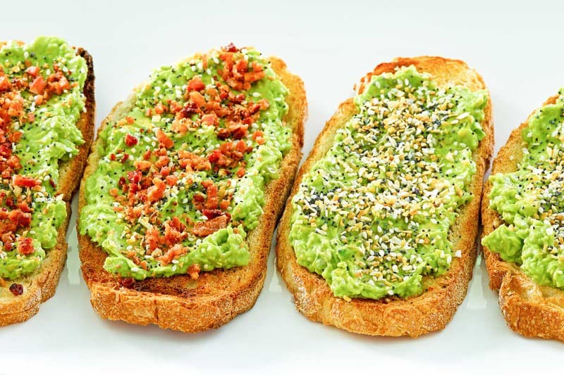 A plate of Dunkin' Donuts Avocado Toast with creamy avocado spread on toasted sourdough bread, topped with seasoning